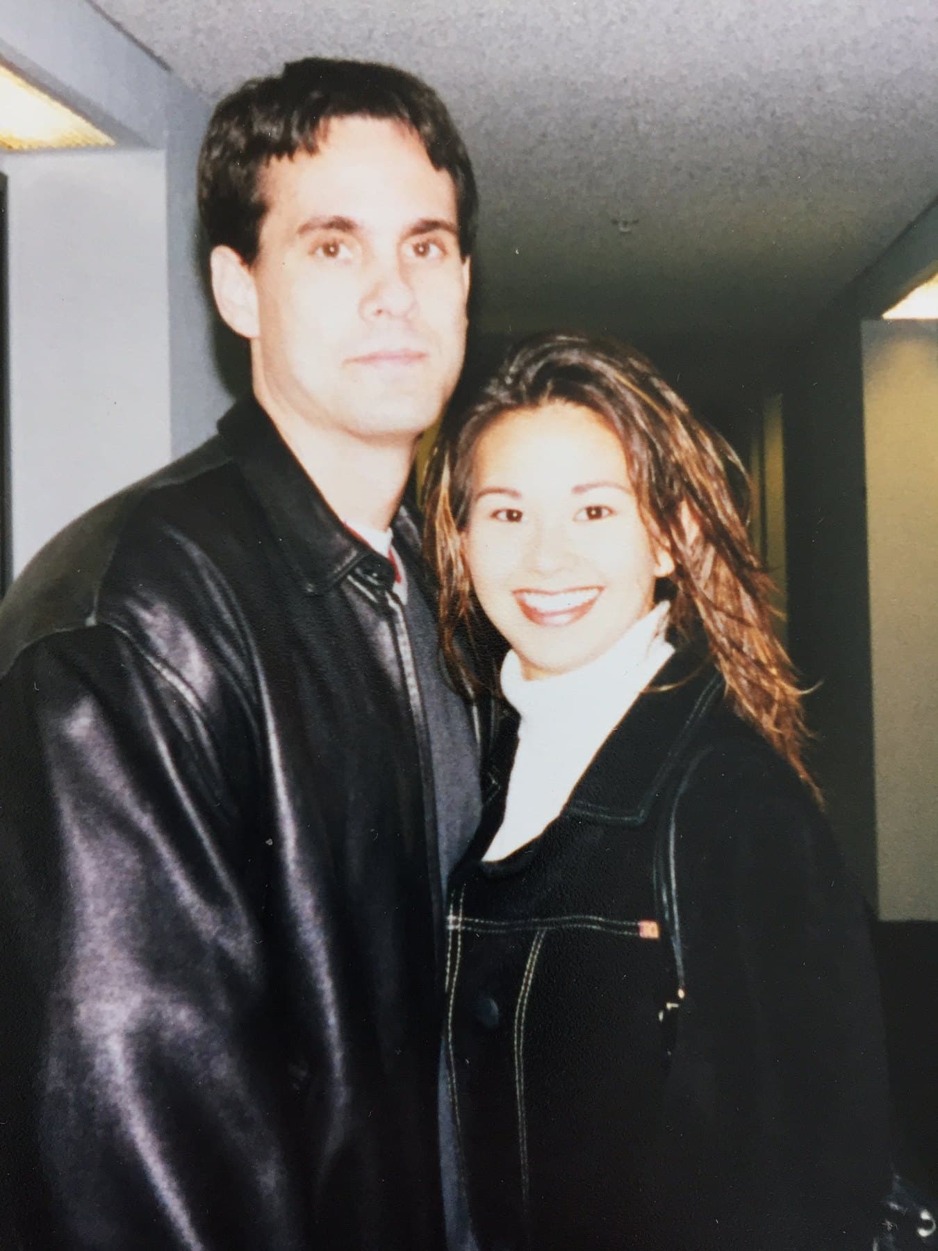 A young Cris and Shirley dressed in black and smiling together