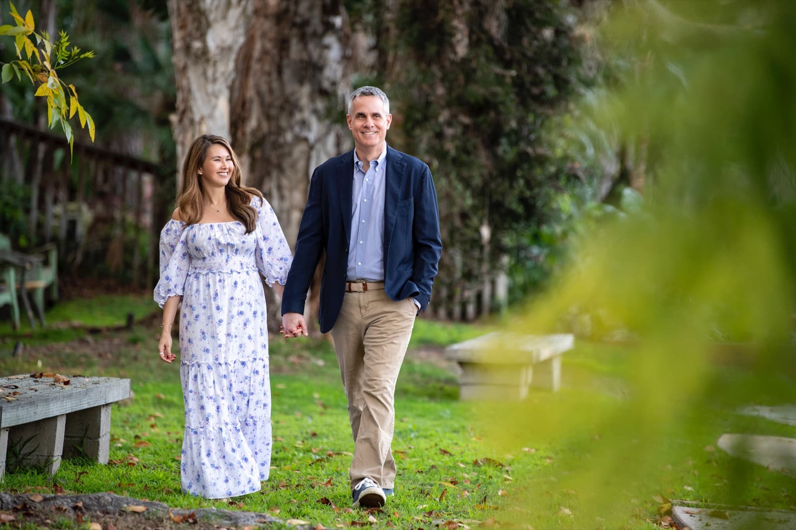 Shirley and Cris walking hand in hand through a garden in 2022